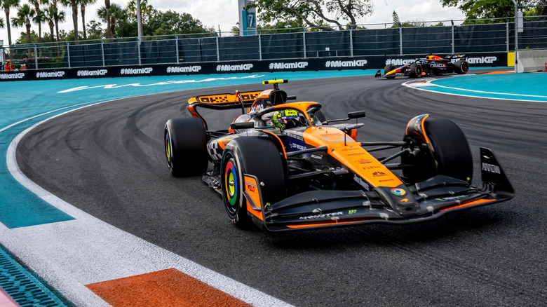 Lando Norris in orange and black McLaren F1 car going around curve at 2024 Miami Grand Prix