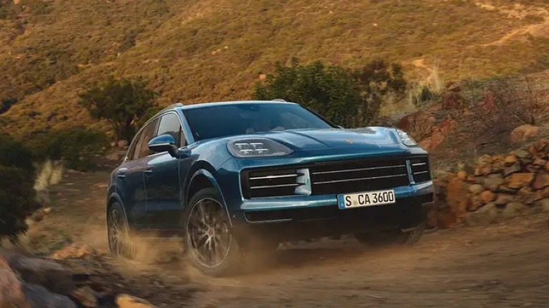 Front shot of a modern Porsche Cayenne driving off-road