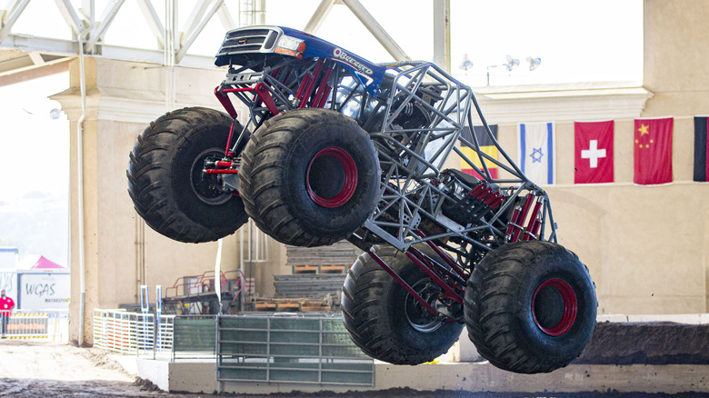 A monster truck taking a jump.