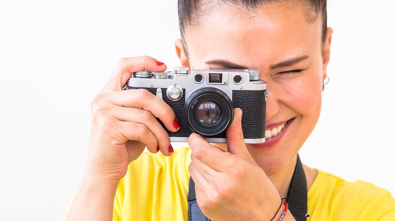 person looking through rangefinder camera