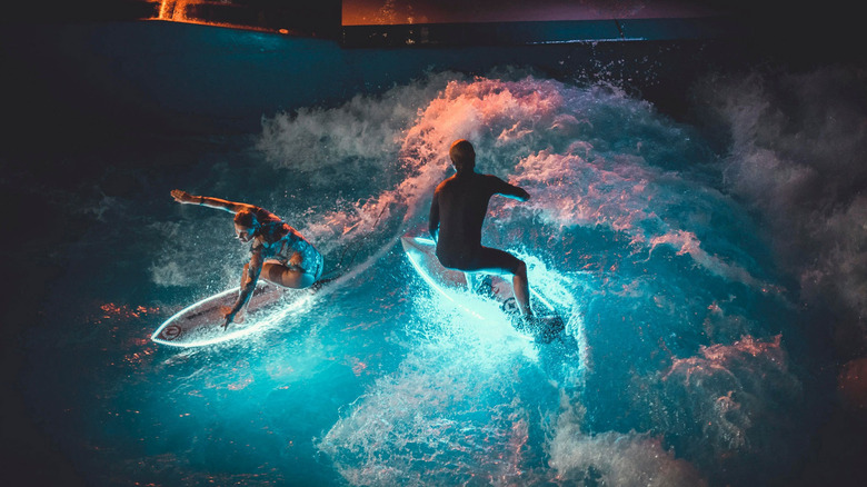 ActionGlow surfers in water