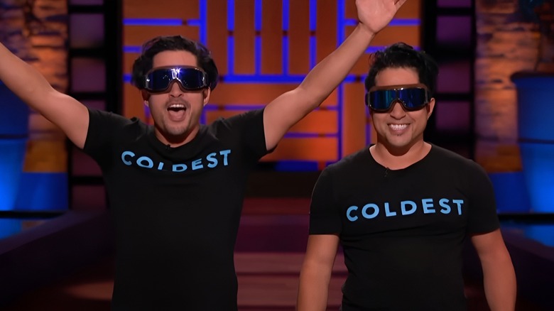 Dave and Joe excitedly presenting while wearing goggles on Shark Tank