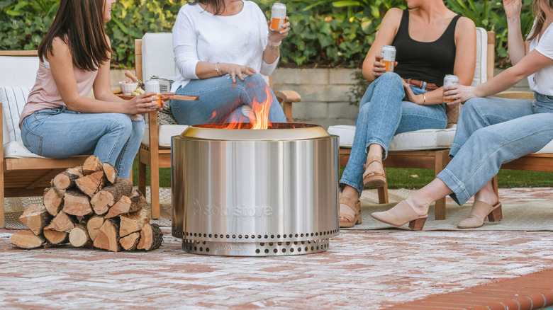 a group of women sitting around a Solo Stove