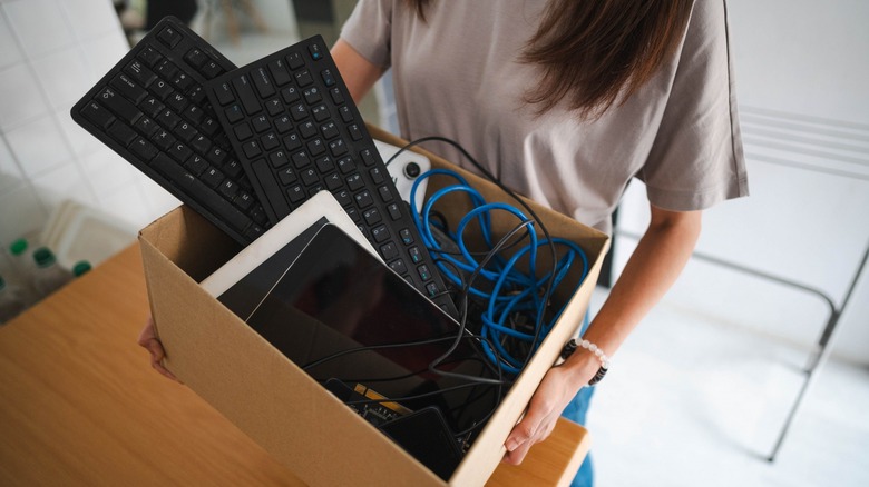 Lady carrying electronics in a box