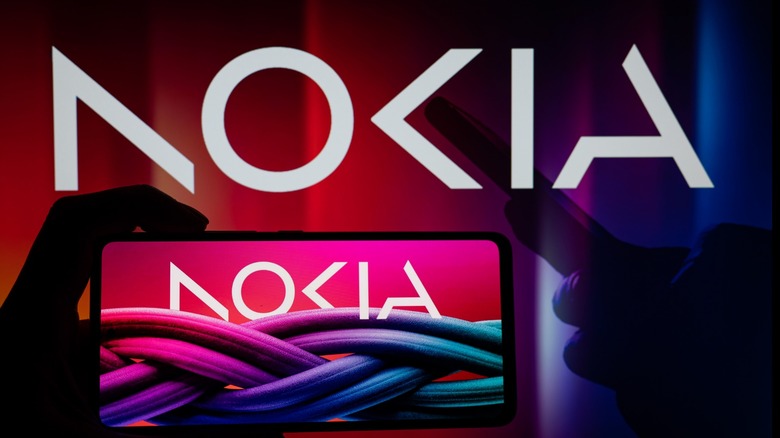 Nokia logo with hands obscured in shadow