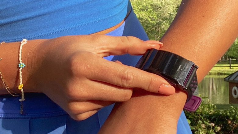 A woman wearing Pavlok Shock Clock in her hand.