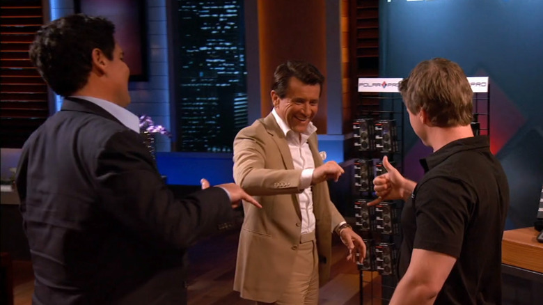 Jeff, Mark, and Robert exchanging hand gesture