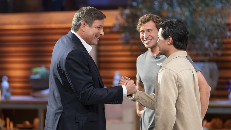 Steven Graf and Zhach Pham shake hands with Todd Graves