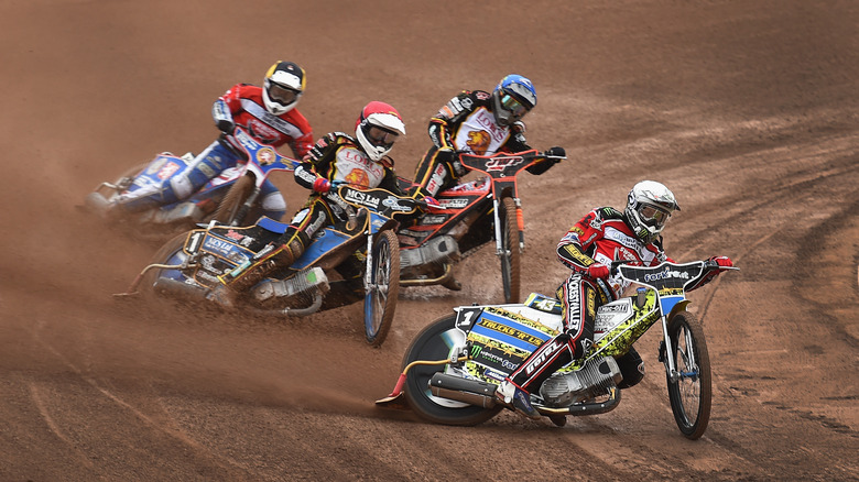 Four speedway riders racing