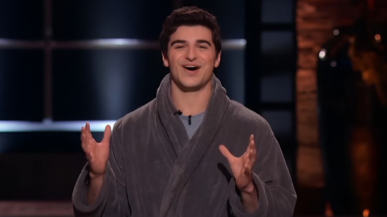 Peter talking on Shark Tank while wearing robe