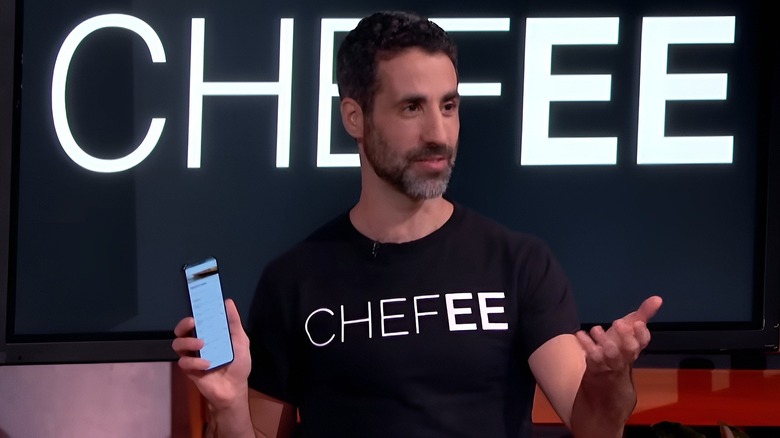 Assaf holding phone in front of Chefee display on Shark Tank