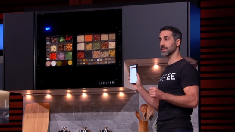 Assaf holding phone next to Chefee display on Shark Tank