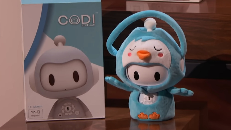 Codi Robot sitting next to box