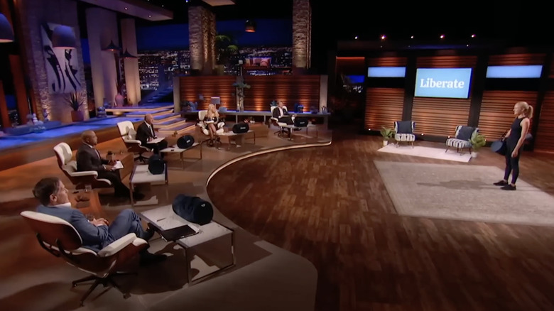 Mark Cuban, Daymond John, Kevin O'Leary, Lori Greiner, and Robert Herjavec listening to Olivia Bowser's pitch for Liberate on the set of "Shark Tank" Season 13