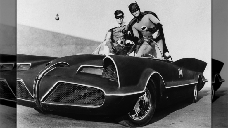 Adam West and Burt Ward as Batman and Robin atop the Batmobile in 1966