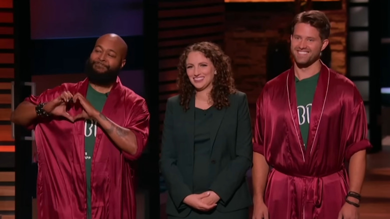 Sterling giving heart symbol as Leigh and Nathan smile