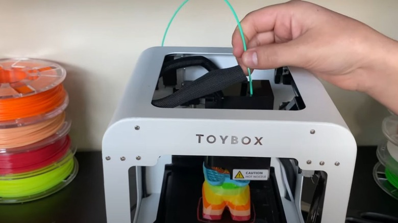 Toybox printer printing a new toy with colored filament.