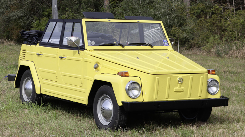 Yellow VW Thing parked in grass field