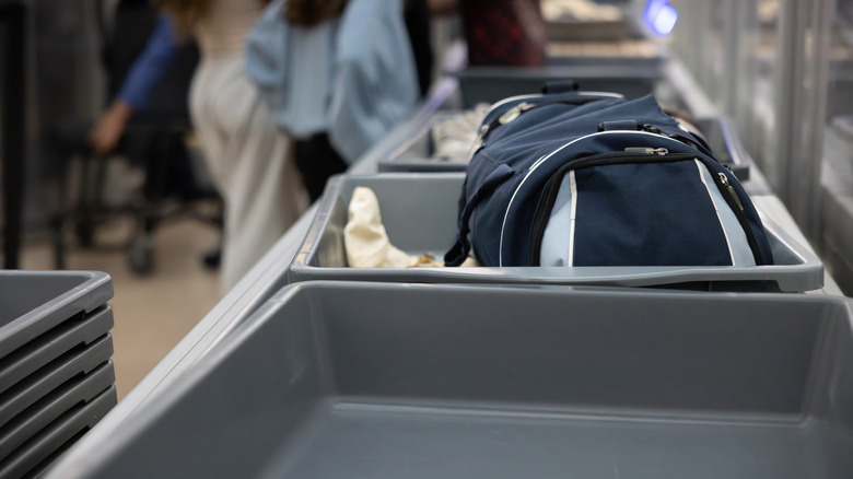 Personal Items Placed In Bins Headed Toward Security Screening In An Airport