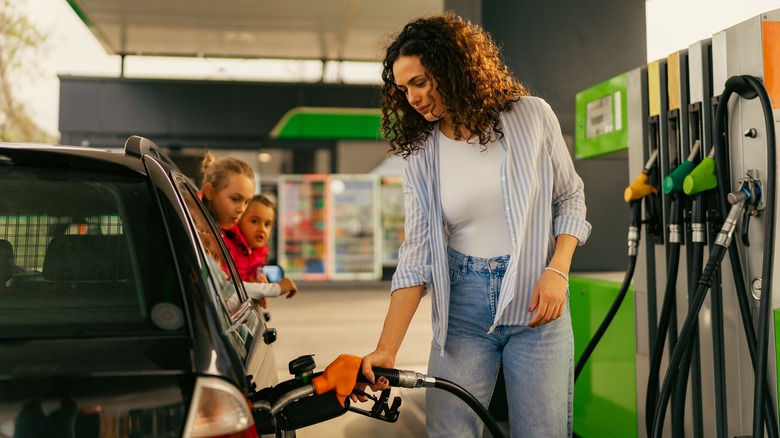 woman filling car with gas