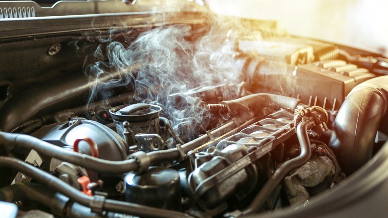 A close-up shot of a smoking engine bay