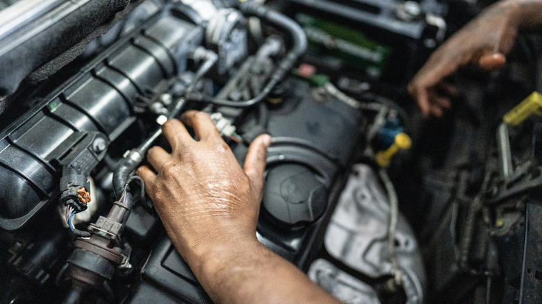 Mechanic's hands repairing a car in an auto repair shop