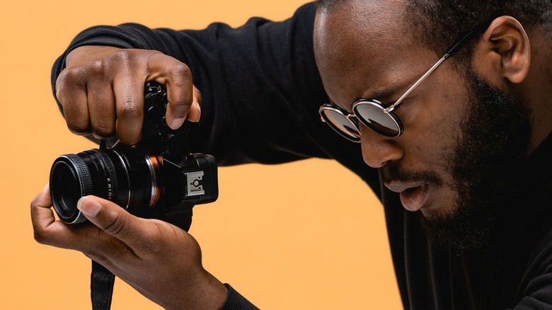 Professional photographer holding a full-frame camera