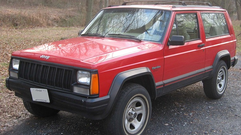 Parked red 1984 Jeep Cherokee