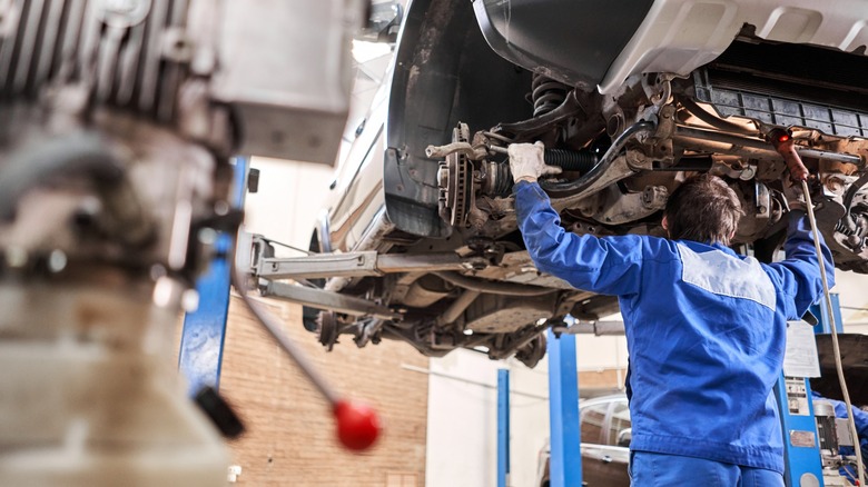 Mechanic looking under a car