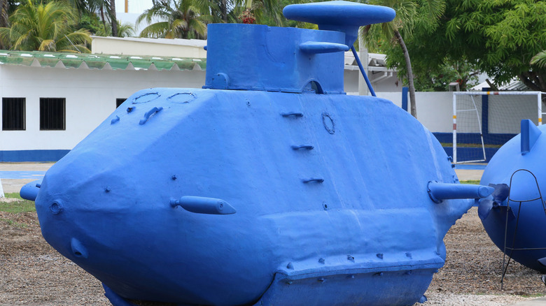 Side view of large grounded narco-sub