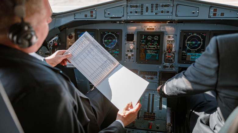 Veteran pilot reviewing flight procedure and plans