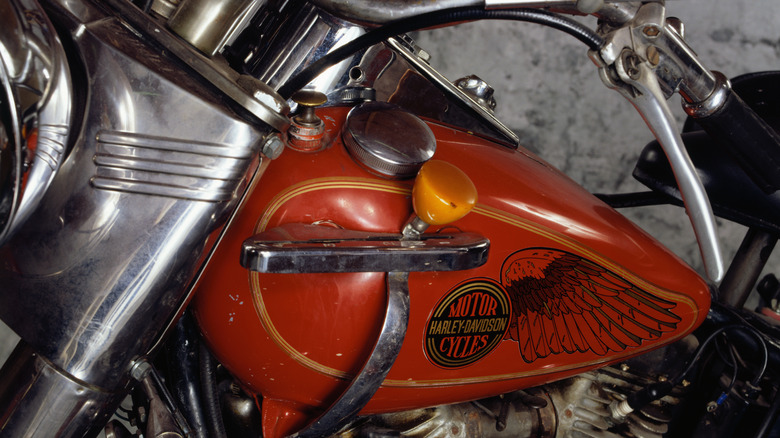 Manual tank shifter on a red vintage Harley Davidson motorcycle