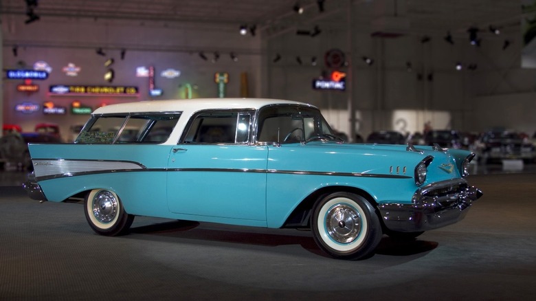 Blue 1957 Chevrolet Nomad parked on a car showroom floor