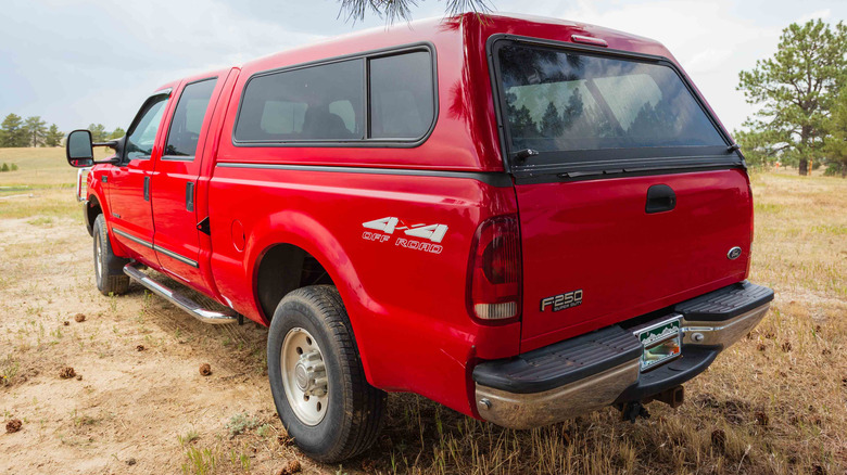 red pickup truck with matching topper on bed