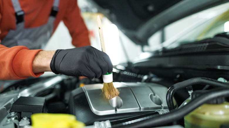 Man cleaning car engine