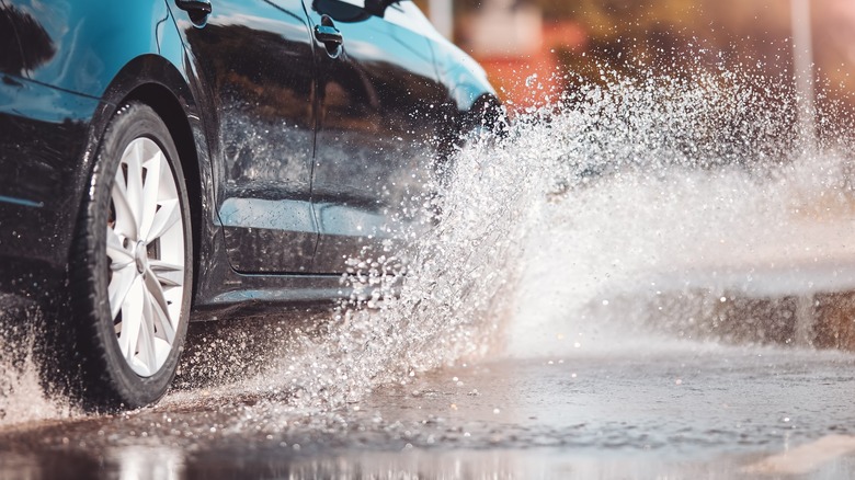 car splashing through rain puddles