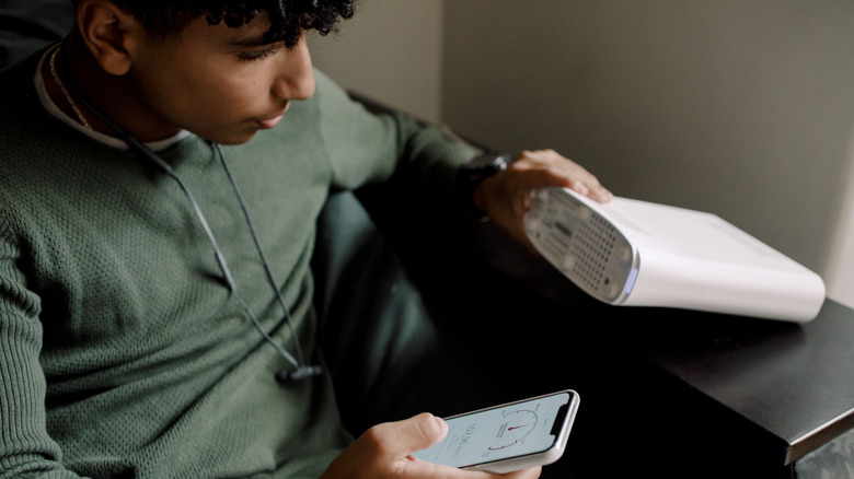 person reading router details off the device