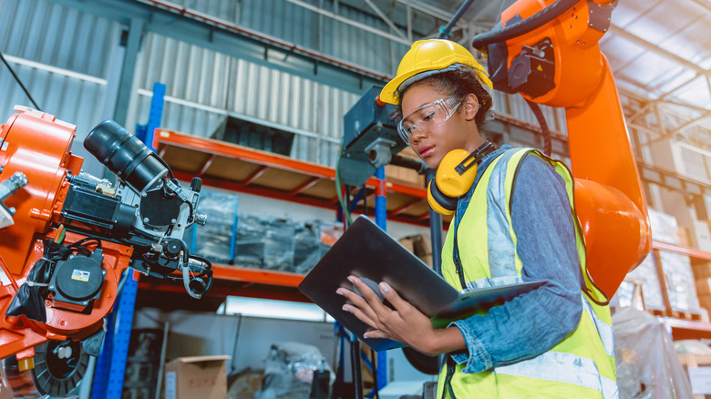 factory worker checking laptop