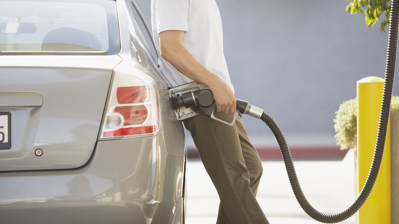 Person pumping fuel into car