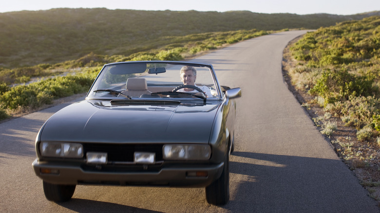 Man in car on road