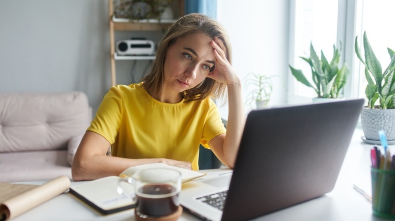 Frustrated woman using a laptop