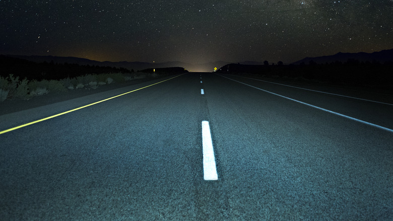 A highway lit at nighttime.