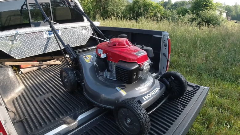 Lawn mower in back of truck 