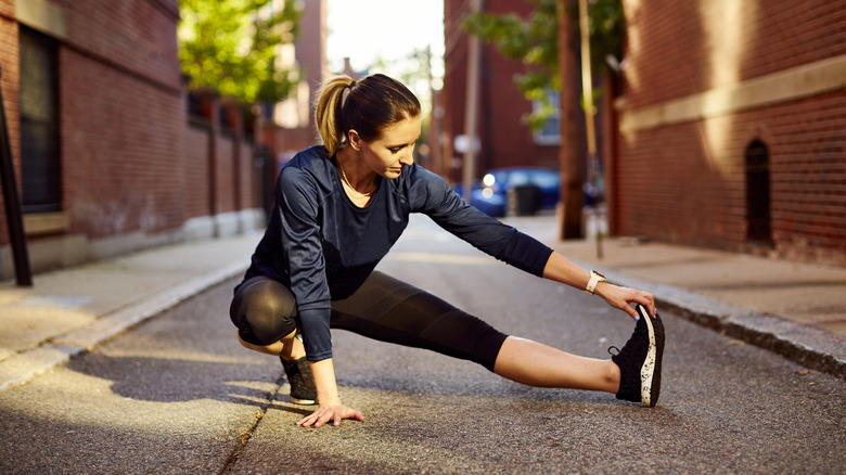 woman stretching on the street