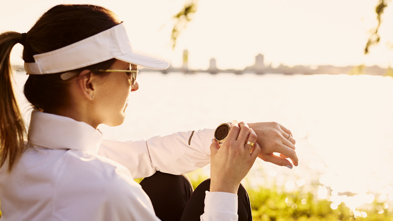 woman pressing smartwatch button