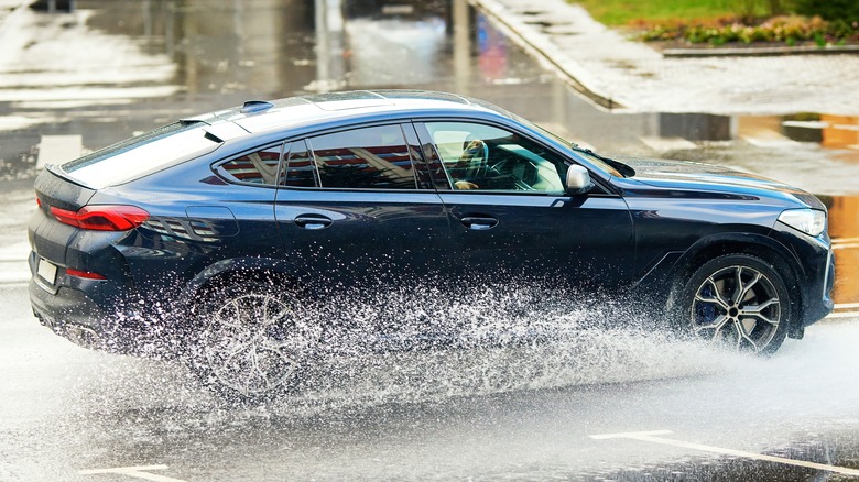 car driving over water on road