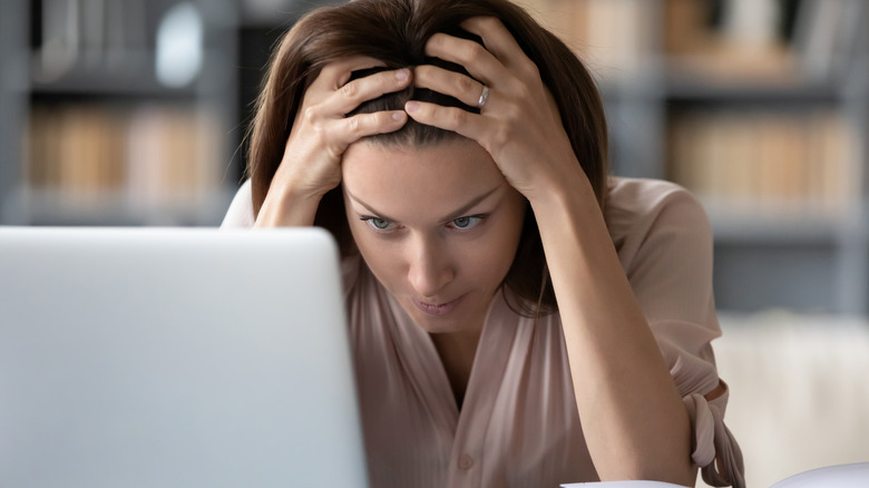 woman frustrated in front of laptop