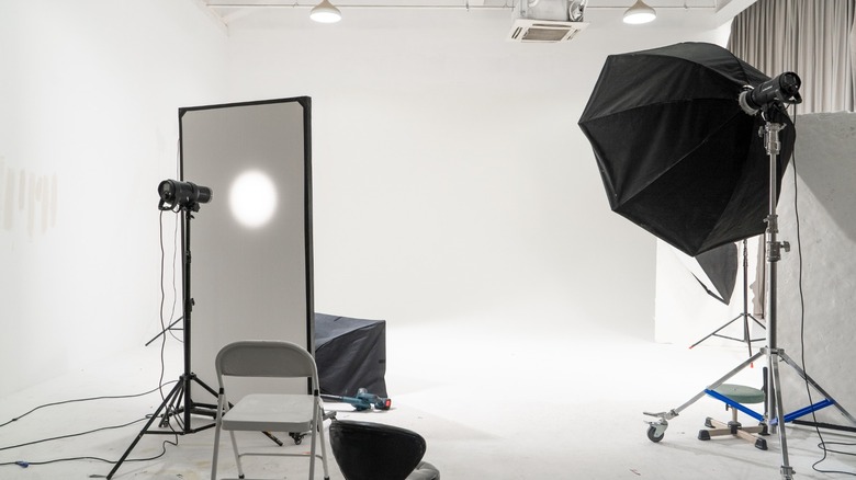 a photo studio with spotlight and umbrella on stands