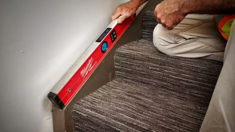 Milwaukee Tools Redstick digital level used on stairs