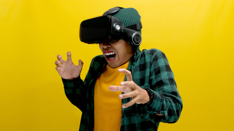 Person screaming in fear wearing VR headset